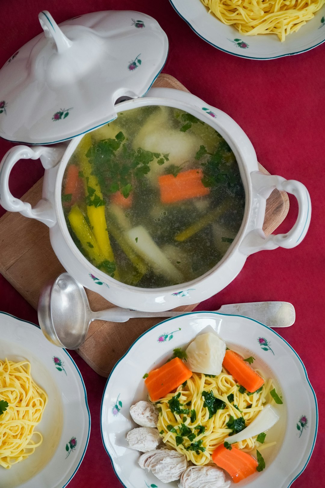 Five bowls of different Czech soups on a wooden table