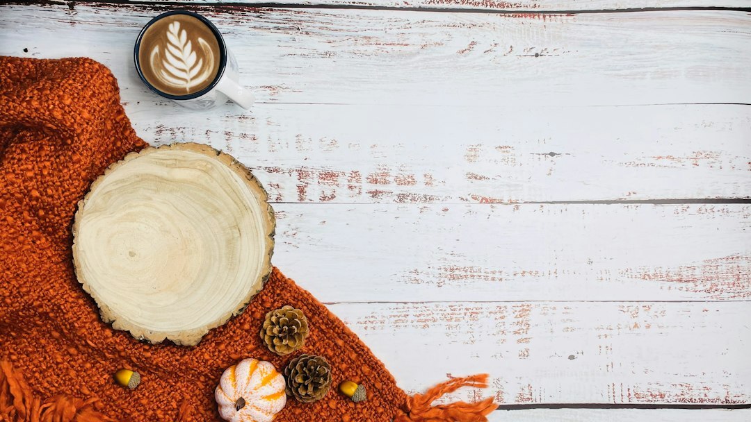 Bowl of warm autumn pumpkin soup on a wooden table