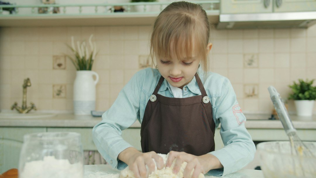Hands kneading dough on a flour dusted kitchen counter