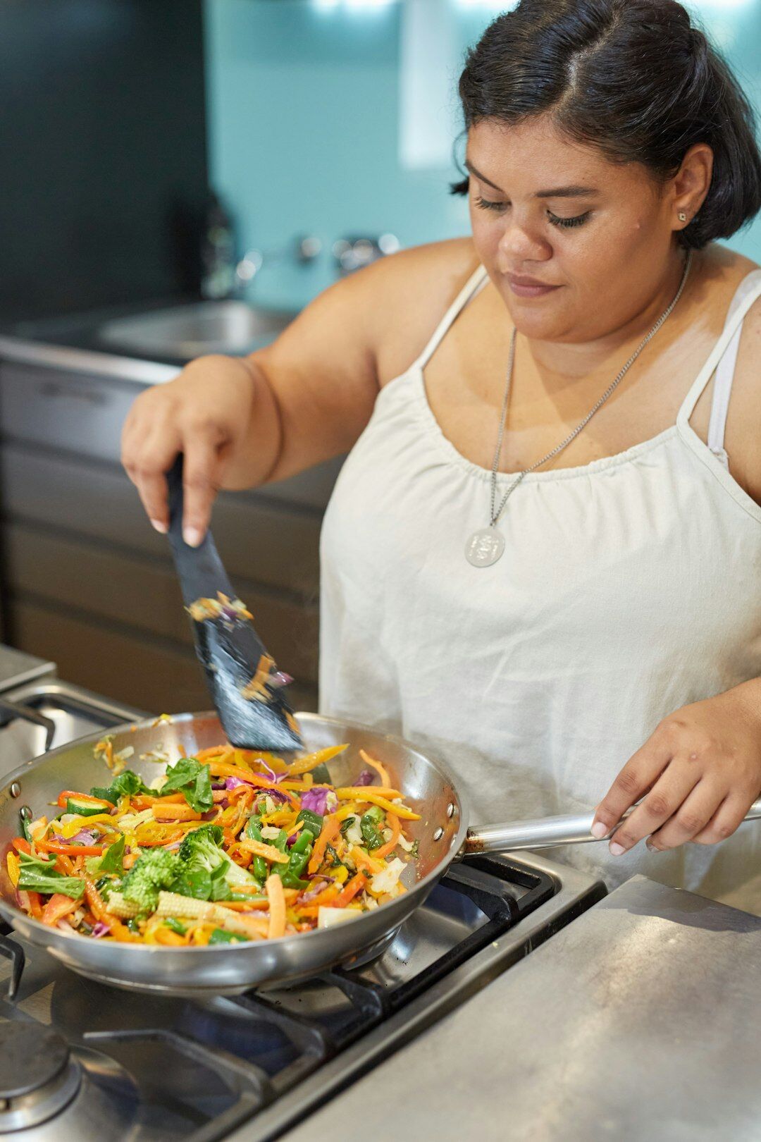 woman cooking with fresh vegetables
